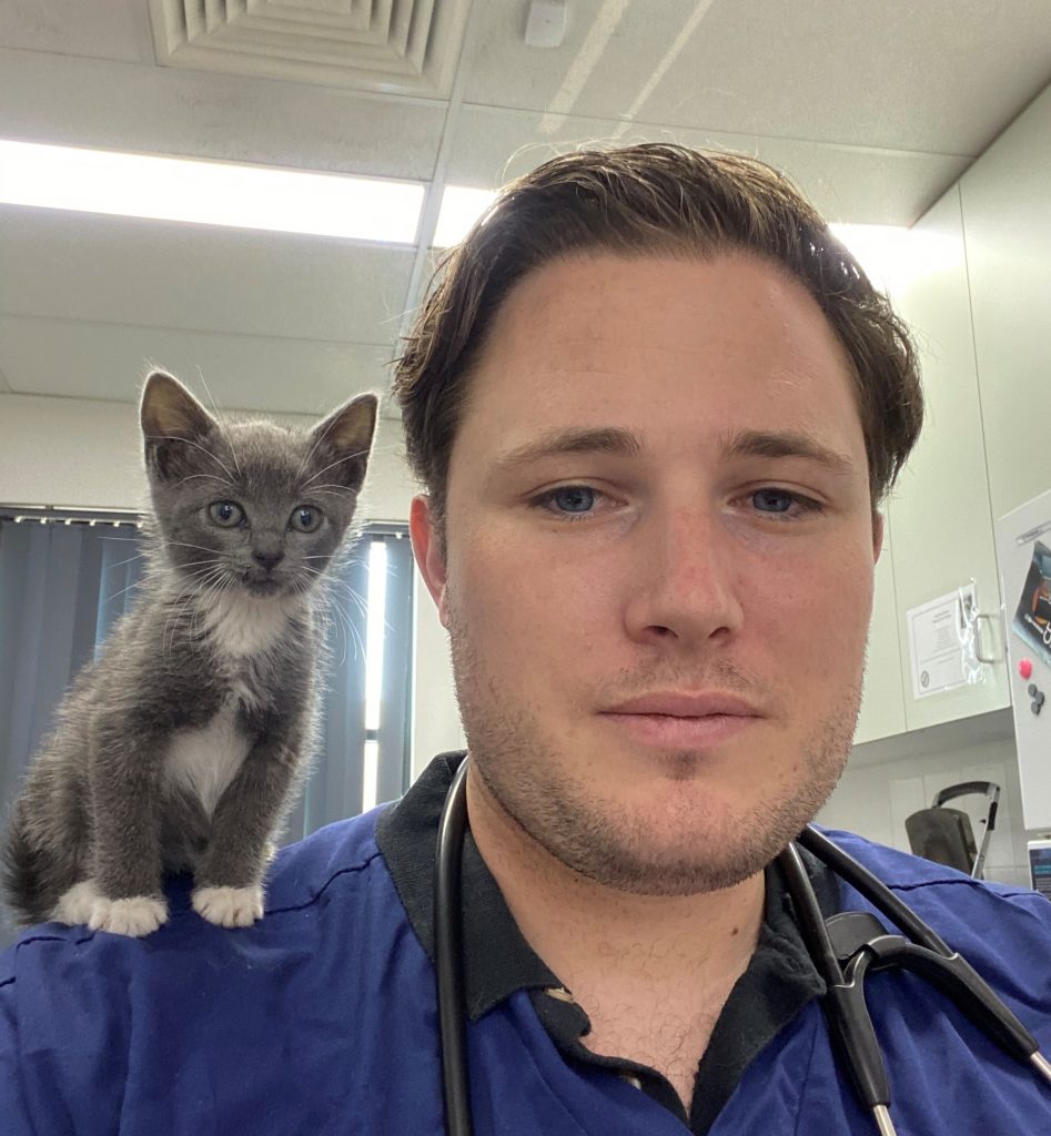 Portrait of Dr Joe Herbert and a kitten